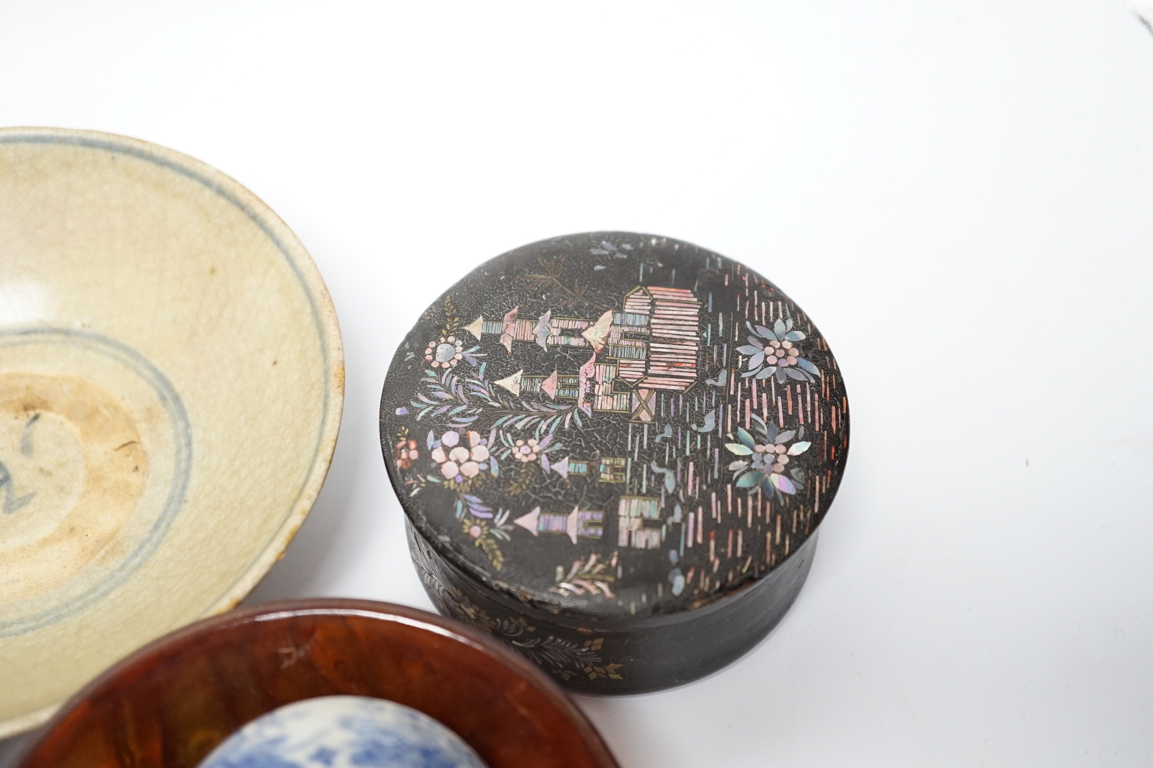 Eleven Chinese or Japanese items including; a bowl, a red lacquer box, an agate carving of a bird group, a carved hardstone lion tortoise, mother of pearl counters, etc.